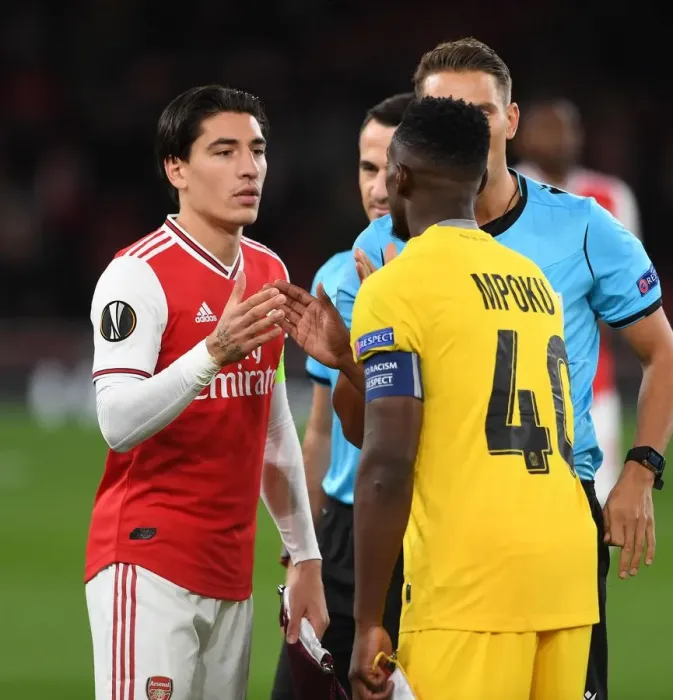 Framed Print : Arsenal vs Standard Liege: Hector Bellerin and Paul-Jose Mpoku Exchange Handshakes in Europa League Match (Arsenal FC 2019-20)
