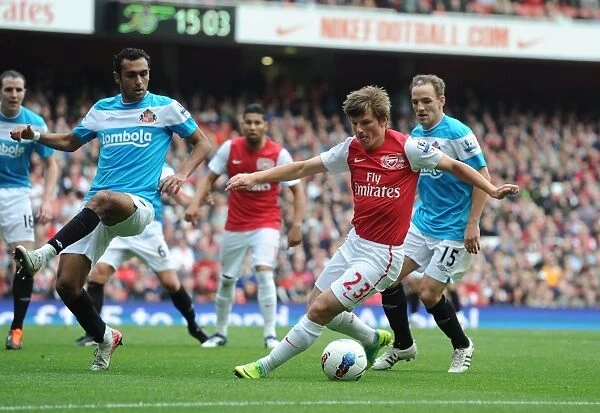 Arsenal vs. Sunderland: Andrey Arshavin Clashes with Defenders in 2011-12 Premier League Match