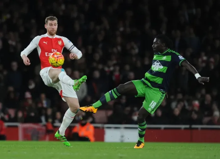 Framed Print : Arsenal vs Swansea Clash: Mertesacker vs Gomis Battle at Emirates Stadium Framed Print : Arsenal vs Swansea Clash: Mertesacker vs Gomis Battle at Emirates Stadium