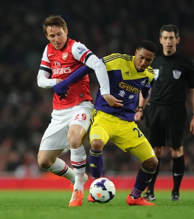 Framed Print : Arsenal vs Swansea: Intense Battle between Kim Kallstrom and Jonathan De Guzman