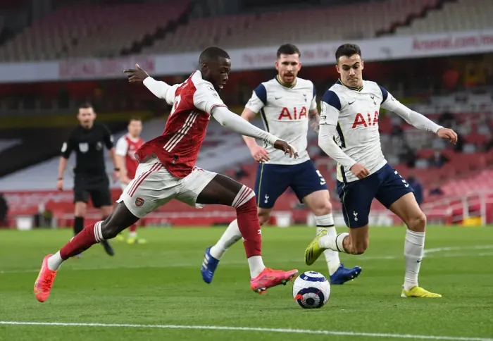 Framed Print : Arsenal vs. Tottenham: Pepe Faces Off Against Reguilon in Intense Premier League Clash Framed Print : Arsenal vs. Tottenham: Pepe Faces Off Against Reguilon in Intense Premier League Clash