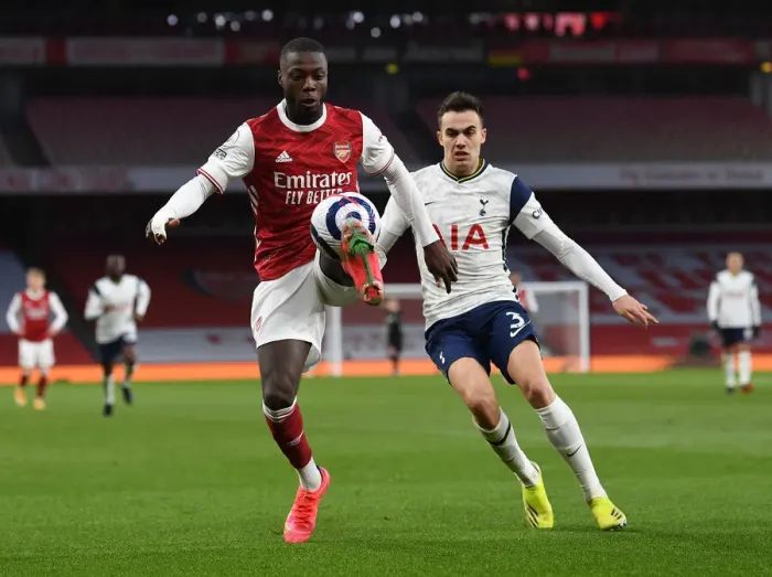 Framed Print : Arsenal vs. Tottenham: Pepe Under Pressure in Intense Premier League Clash