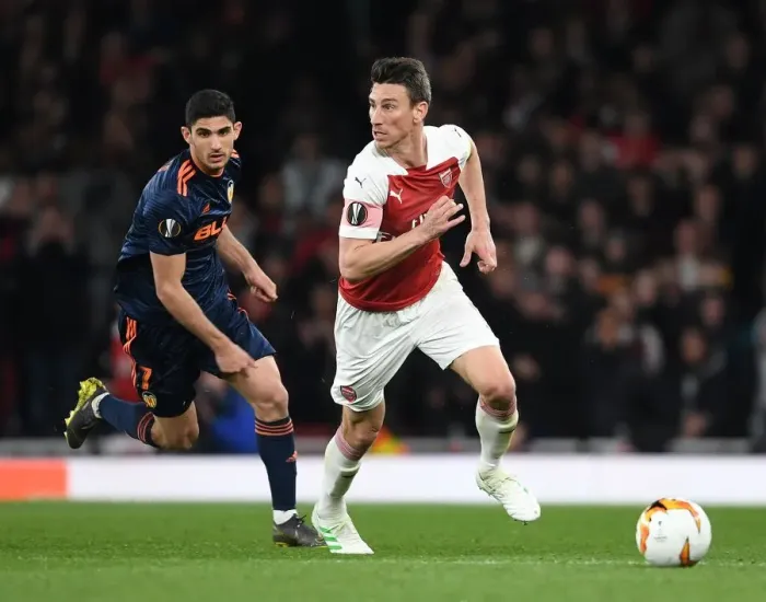 Framed Print : Arsenal vs Valencia: Koscielny Breaks Past Guedes in Europa League Semi-Final Showdown