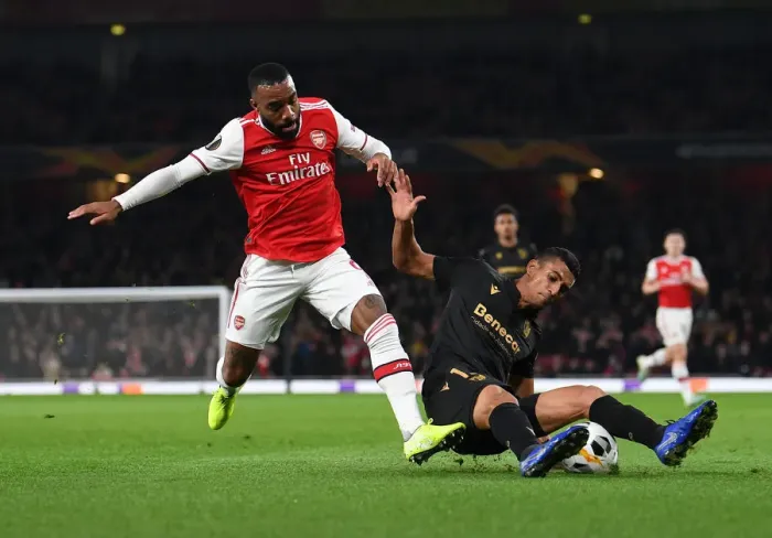 Framed Print : Arsenal vs. Vitoria Guimaraes: Lacazette Tackled in Europa League Clash Framed Print : Arsenal vs. Vitoria Guimaraes: Lacazette Tackled in Europa League Clash