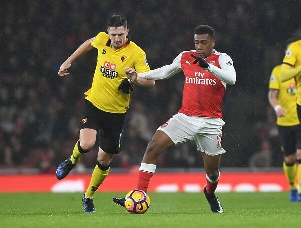 Arsenal vs. Watford: Intense Clash Between Alex Iwobi and Craig Cathcart in the Premier League