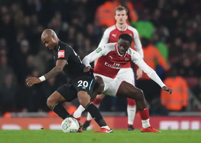 Framed Print : Arsenal vs. West Ham: Dasilva Tackles Ayew in Carabao Cup Showdown