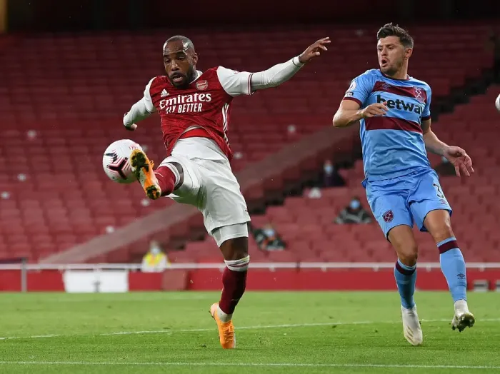 Framed Print : Arsenal vs. West Ham: Lacazette Faces Off Against Cresswell in Premier League Showdown