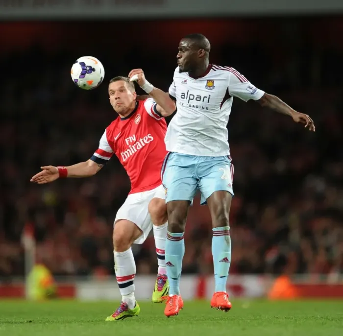 Framed Print : Arsenal vs. West Ham: Podolski vs. Demel - Premier League Clash at Emirates Stadium