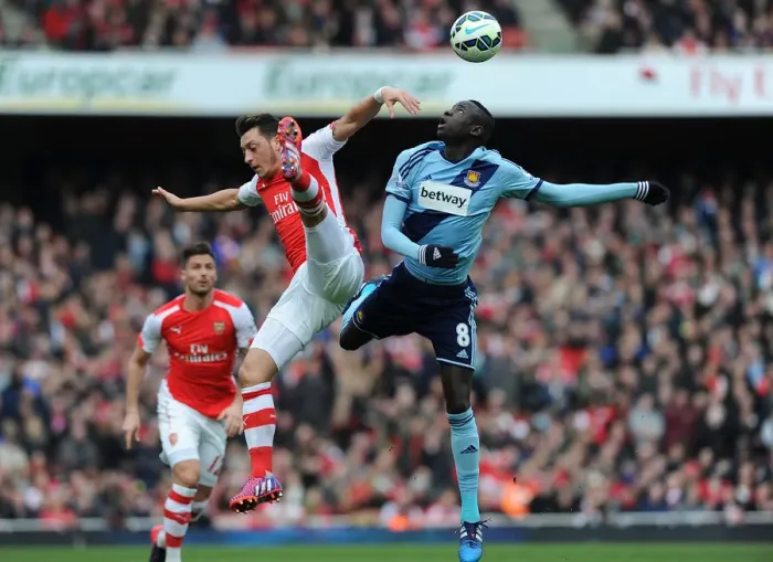 Framed Print : Arsenal vs. West Ham United: Intense Clash between Ozil and Kouyate in the Premier League Framed Print : Arsenal vs. West Ham United: Intense Clash between Ozil and Kouyate in the Premier League