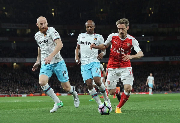Arsenal vs. West Ham United: Monreal Stands Firm Against Ayew and Collins