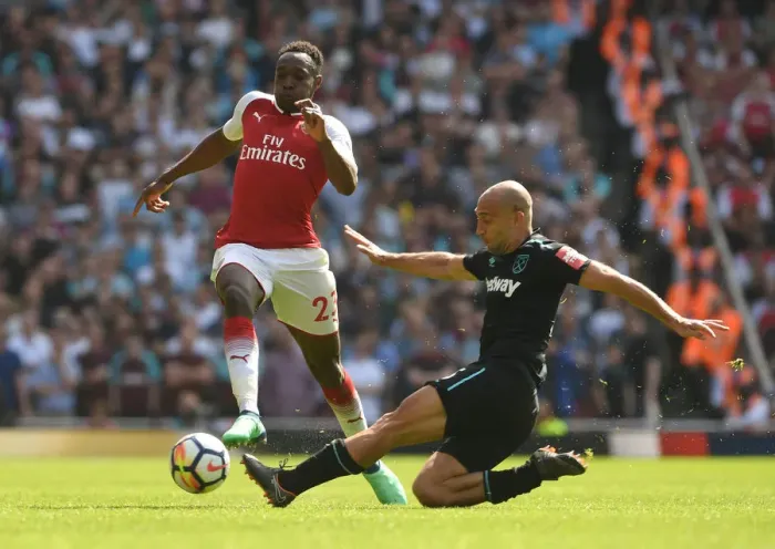 Framed Print : Arsenal vs. West Ham: Welbeck Leaps Over Zabaleta in Intense Premier League Clash