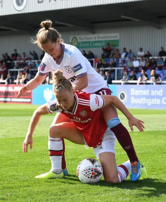 Framed Print : Arsenal vs West Ham Women's Football: Intense Battle at Meadow Park