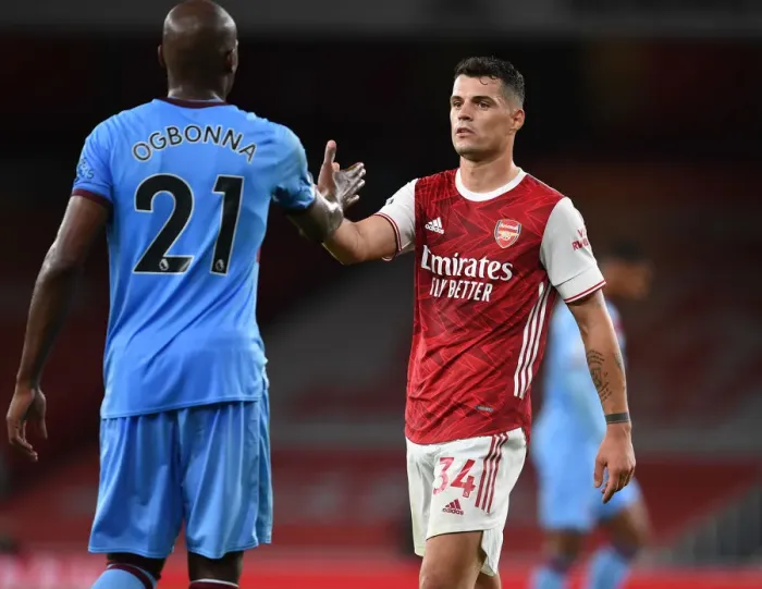 Framed Print : Arsenal vs. West Ham: Xhaka and Ogbonna Share a Moment after Premier League Clash