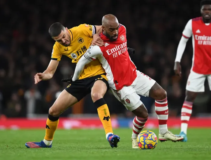 Framed Print : Arsenal vs. Wolverhampton Wanderers: Lacazette vs. Coady - Premier League Showdown: A Battle of Stars at Emirates Stadium