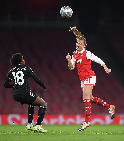 Arsenal WFC vs Juventus FC: Clash in the UEFA Women's Champions League - Lia Walti Heads the Ball Clear