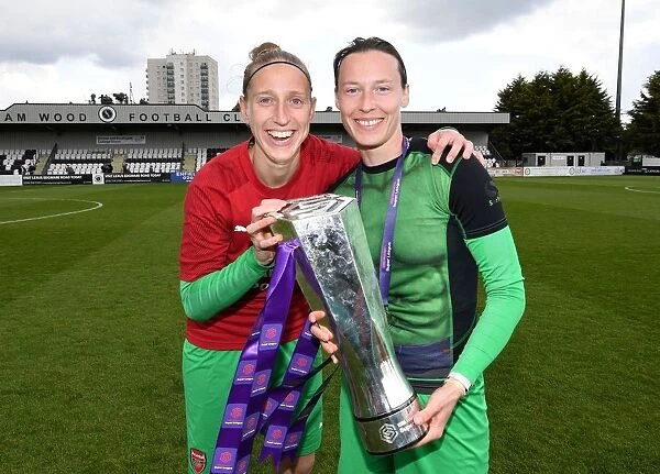 Arsenal Women Celebrate WSL Title Triumph: Sari van Veenendaal and Pauline Peyraud-Magnin Hold the Trophy