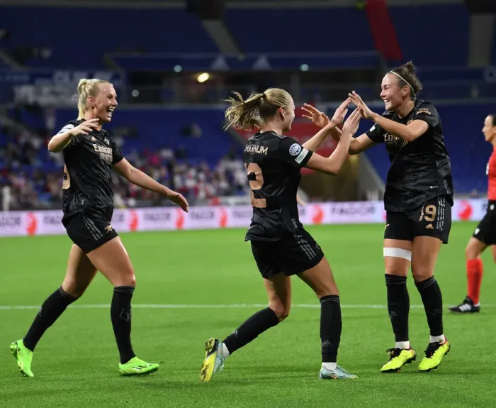 Framed Print : Arsenal Women's Double Strike: Celebrating Goals Against Olympique Lyonnais in UEFA Women's Champions League
