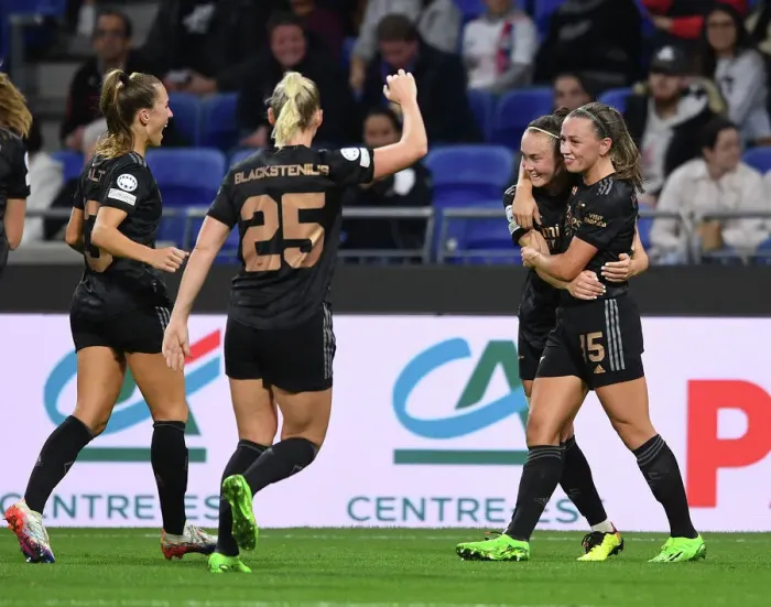 Framed Print : Arsenal Women's Team Celebrates Goals Against Olympique Lyonnais in UEFA Womens Champions League