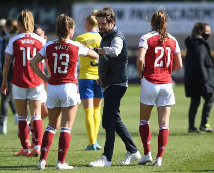 Framed Print : Arsenal Women's Victory: Montemurro Fists Bump Jubilant Player Amidst Empty Stands vs. Brighton & Hove Albion (FA WSL, 2021)
