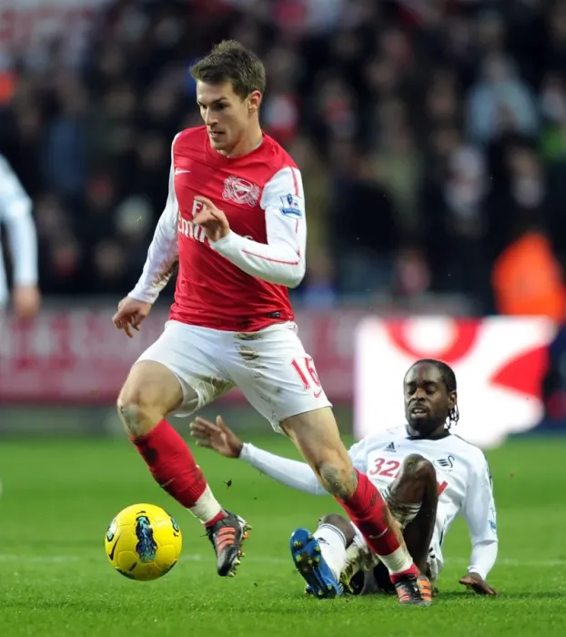 Framed Print : Arsenal's Aaron Ramsey Battles Nathan Dyer of Swansea for Ball Possession in Premier League Clash