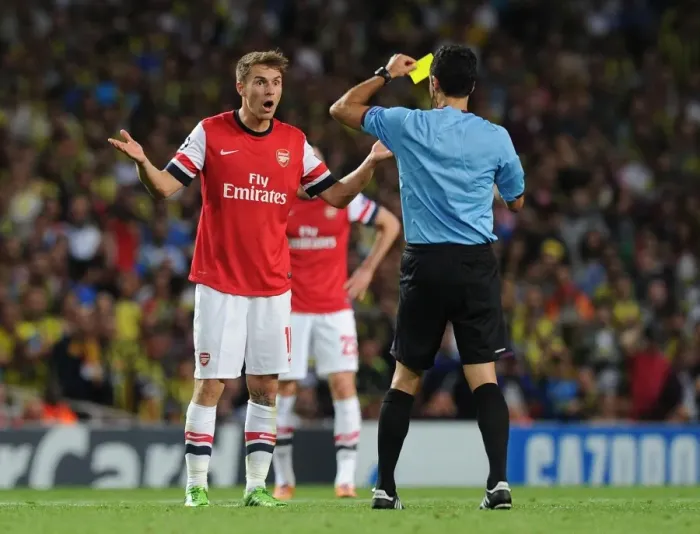 Framed Print : Arsenal's Aaron Ramsey Booked by Referee Velasco Carballo in Champions League Clash vs Fenerbahce Framed Print : Arsenal's Aaron Ramsey Booked by Referee Velasco Carballo in Champions League Clash vs Fenerbahce