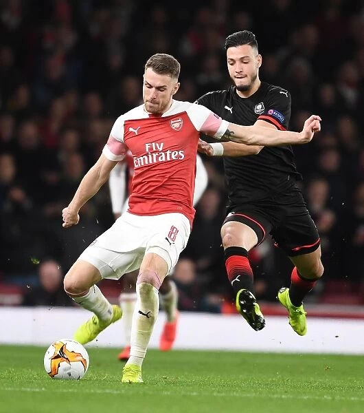 Arsenal's Aaron Ramsey Breaks Past Rennes Bensebaini in Europa League Clash