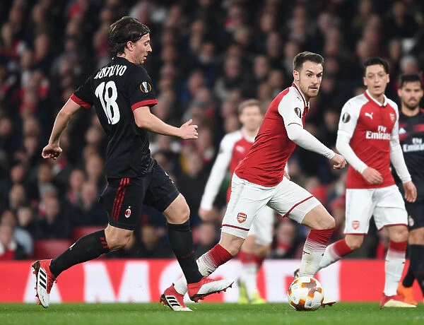 Arsenal's Aaron Ramsey Clashes with AC Milan's Riccardo Montolivo in Europa League Showdown