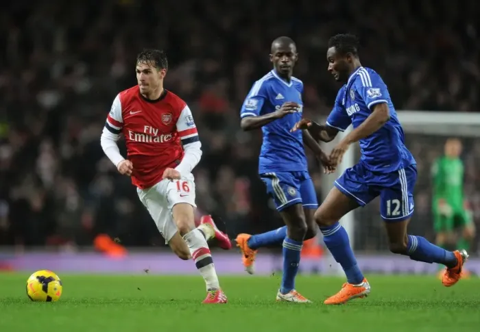 Framed Print : Arsenal's Aaron Ramsey Clashes with Chelsea's John Obi Mikel in Premier League Showdown Framed Print : Arsenal's Aaron Ramsey Clashes with Chelsea's John Obi Mikel in Premier League Showdown