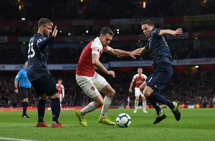 Framed Print : Arsenal's Aaron Ramsey Clashes with Manchester United's Luke Shaw and Nemanja Matic