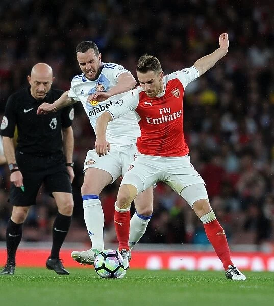 Arsenal's Aaron Ramsey Clashes with Sunderland's John O'Shea during Premier League Match