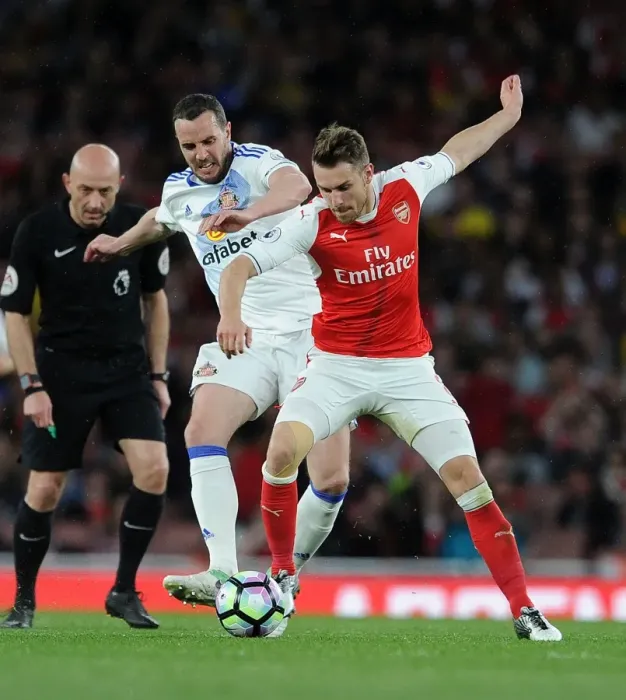 Framed Print : Arsenal's Aaron Ramsey Clashes with Sunderland's John O'Shea during Premier League Match
