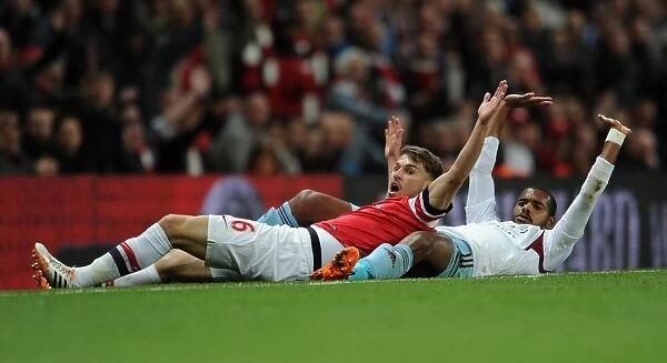 Arsenal's Aaron Ramsey Clashes with West Ham's Ricardo Vaz Te in Intense Premier League Match