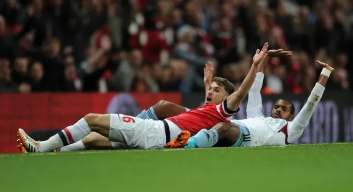 Framed Print : Arsenal's Aaron Ramsey Clashes with West Ham's Ricardo Vaz Te in Intense Premier League Match