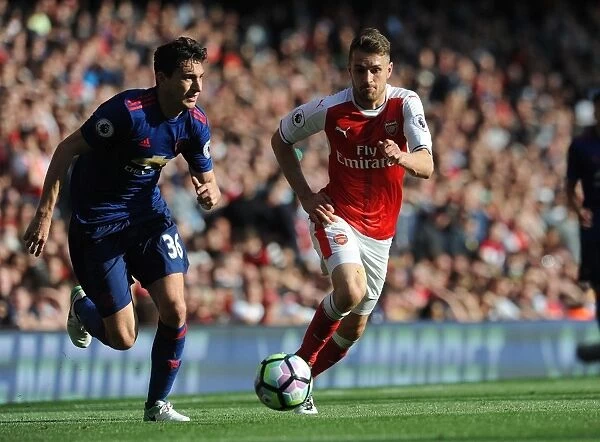 Arsenal's Aaron Ramsey Closes In on Manchester United's Matteo Darmian in Intense Premier League Showdown