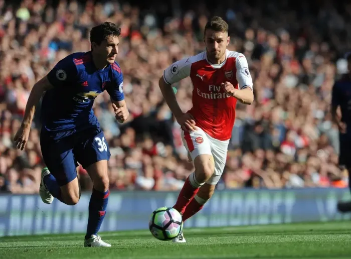 Framed Print : Arsenal's Aaron Ramsey Closes In on Manchester United's Matteo Darmian in Intense Premier League Showdown Framed Print : Arsenal's Aaron Ramsey Closes In on Manchester United's Matteo Darmian in Intense Premier League Showdown