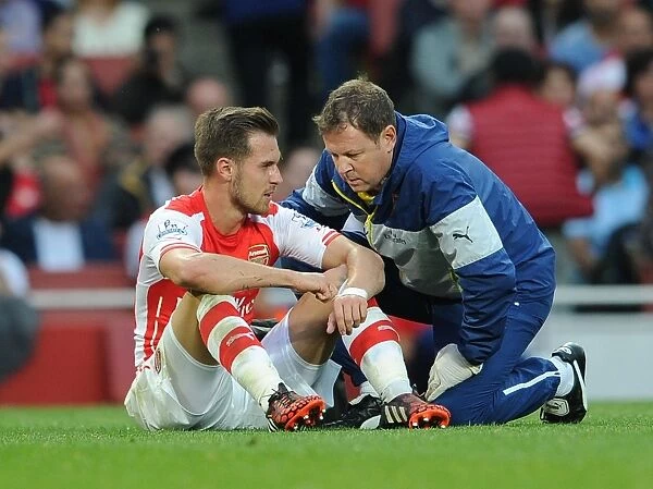 Arsenal's Aaron Ramsey Consults Physio Colin Lewin During Arsenal v Tottenham Clash