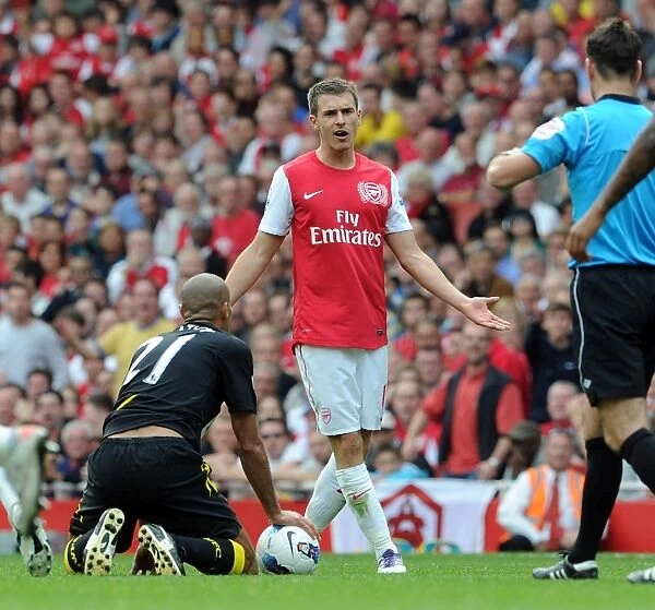 Arsenal's Aaron Ramsey Contests Referee's Call Amidst Arsenal's 3-0 Victory Over Bolton Wanderers