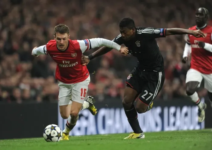Framed Print : Arsenal's Aaron Ramsey Faces Off Against Bayern Munchen's David Alaba in Champions League Showdown Framed Print : Arsenal's Aaron Ramsey Faces Off Against Bayern Munchen's David Alaba in Champions League Showdown