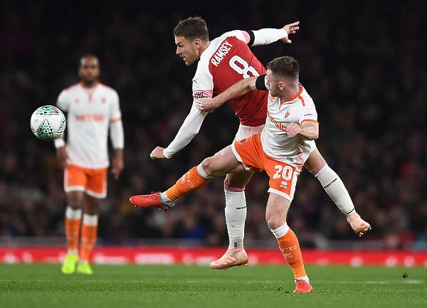 Arsenal's Aaron Ramsey Faces Off Against Blackpool's Oliver Turton in Carabao Cup Clash