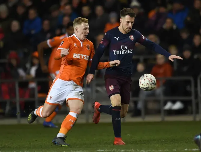 Framed Print : Arsenal's Aaron Ramsey Faces Off Against Blackpool's Callum Guy in FA Cup Clash Framed Print : Arsenal's Aaron Ramsey Faces Off Against Blackpool's Callum Guy in FA Cup Clash