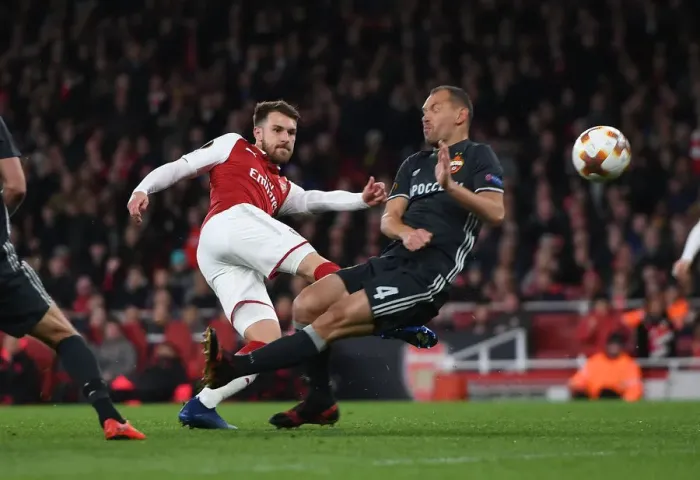 Framed Print : Arsenal's Aaron Ramsey Faces Off Against CSKA Moscow's Sergei Ignashevich in Europa League Quarterfinal Showdown
