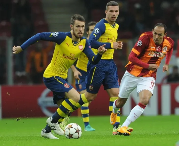 Framed Print : Arsenal's Aaron Ramsey Faces Off Against Galatasaray's Umut Bulut in UEFA Champions League Clash Framed Print : Arsenal's Aaron Ramsey Faces Off Against Galatasaray's Umut Bulut in UEFA Champions League Clash
