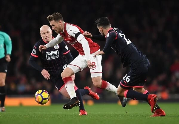 Arsenal's Aaron Ramsey Faces Off Against Huddersfield's Aaron Mooy and Christopher Schindler