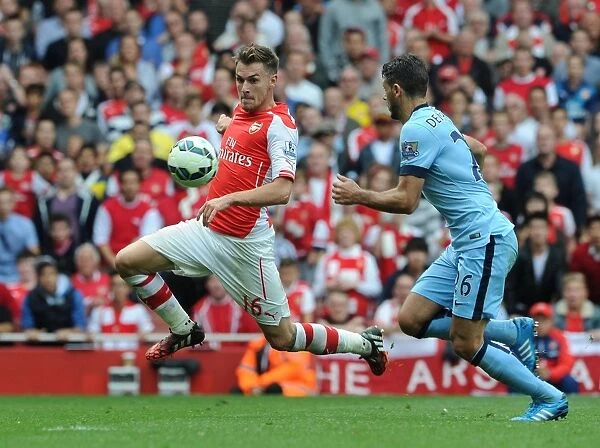 Arsenal's Aaron Ramsey Faces Off Against Manchester City's Martin Demichelis in Intense Premier League Clash