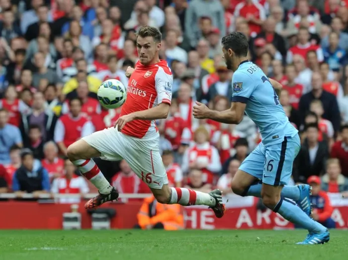 Framed Print : Arsenal's Aaron Ramsey Faces Off Against Manchester City's Martin Demichelis in Intense Premier League Clash Framed Print : Arsenal's Aaron Ramsey Faces Off Against Manchester City's Martin Demichelis in Intense Premier League Clash