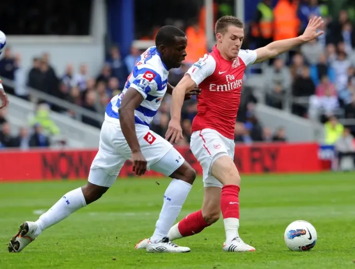 Framed Print : Arsenal's Aaron Ramsey Faces Off Against Nedum Onuoha in Intense Queens Park Rangers Clash