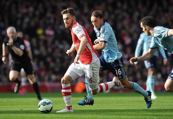 Arsenal's Aaron Ramsey Faces Off Against Noble and O'Brien of West Ham