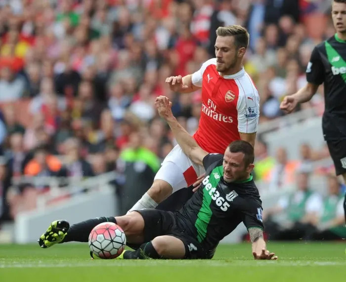 Framed Print : Arsenal's Aaron Ramsey Faces Off Against Phil Bardsley in Intense Premier League Clash Framed Print : Arsenal's Aaron Ramsey Faces Off Against Phil Bardsley in Intense Premier League Clash