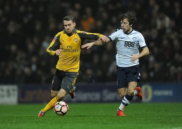 Arsenal's Aaron Ramsey Faces Off Against Preston North End's Ben Pearson in FA Cup Clash