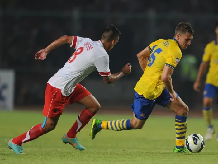 Framed Print : Arsenal's Aaron Ramsey Faces Off Against Raphael Maitimo of Indonesia Dream Team Framed Print : Arsenal's Aaron Ramsey Faces Off Against Raphael Maitimo of Indonesia Dream Team